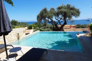 a swimming pool in a villa with a view of the ocean at Anemos Villa Barbati Corfu in Barbati