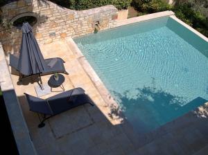 an overhead view of a swimming pool with an umbrella and a chair at Anemos Villa Barbati Corfu in Barbati