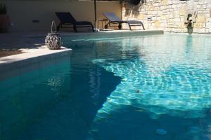 two chairs sitting next to a swimming pool at Anemos Villa Barbati Corfu in Barbati +40 photos