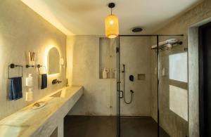 a bathroom with a shower and a sink at C Roque Beach Resort in Colva