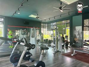 a gym with tread machines and people in it at Staycation Homestay 14 P Residence kuching condo in Kuching