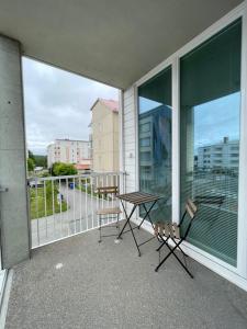 a balcony with a table and chairs on a balcony at Nordica central apartment in Rovaniemi
