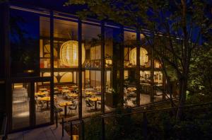 a restaurant with tables outside of a building at night at Ace Hotel Kyoto in Kyoto