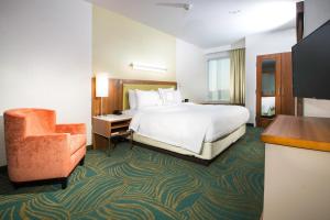 a hotel room with a bed and a chair at SpringHill Suites by Marriott Houston Westchase in Houston
