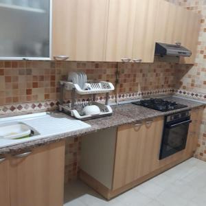 a kitchen with a sink and a counter top at Appartement bord de mer à Nabeul in Nabeul