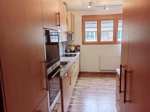 a kitchen with a refrigerator and a sink at Ferienhaus Emi 