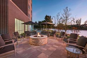 a fire pit on a patio with chairs and tables at Courtyard by Marriott Houston Sugar Land/Lake Pointe in Sugar Land
