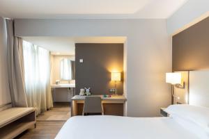 A bed or beds in a room at AC Hotel by Marriott Marseille Prado Vélodrome