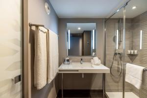 a bathroom with a sink and a shower at AC Hotel by Marriott Marseille Prado Vélodrome in Marseille