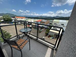 a balcony with a table and a chair on a balcony at Tung Shiang Homestay in Sanyi