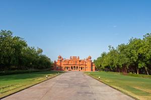 a large brick building on a field of grass at Gaj Kesri by 7Apple Resorts in Bikaner