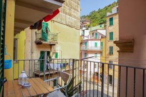 a balcony with a wooden table on a building at Casa Adriana in Riomaggiore
