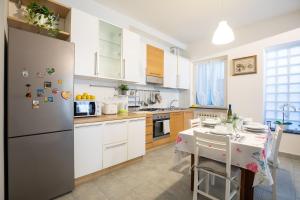 a kitchen with a stainless steel refrigerator and a table at Casa Adriana in Riomaggiore
