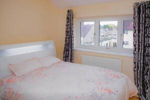 a bedroom with a bed and a window at Immaculate 3-Bed House in Dudley in Dudley