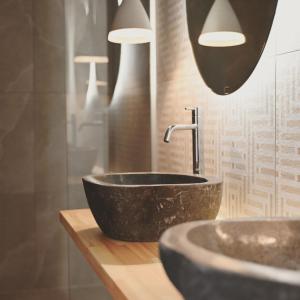 a bathroom with a black bowl sink and lights at Acacia - Explore your senses in Preveza