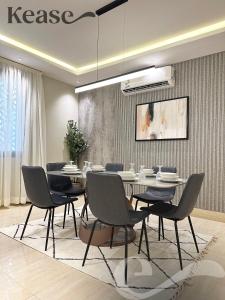 a dining room with a table and chairs at Kease Malqa B-4 Royal Touch AZ31 in Riyadh