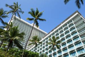 a large building with palm trees in front of it at Sheraton Princess Kaiulani in Honolulu