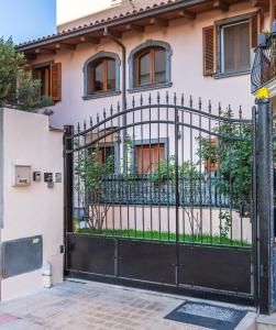 a black gate in front of a house at Casa Lilla 1 e 2 in Oristano