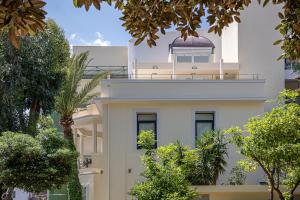 a white building with a balcony on top of it at Avra City Boutique Hotel in Chania Town
