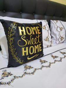 a home sweet home pillow on a bed at G&G Homes WESTINDIES in Eldoret