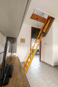 a wooden staircase in a room with a living room at Spazio Ancora appartamento a 500 m. dal mare in Rimini