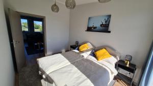 a bedroom with a bed with white and yellow pillows at Float House Nr 659 in Rīga