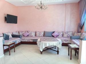 a living room with a couch and a table at Villa in Oulad Akkou