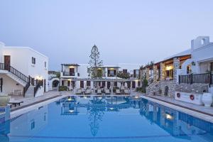 a large swimming pool in front of a house at Contaratos Beach Hotel in Naousa