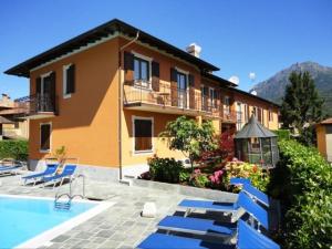 a building with a swimming pool next to a house at Hotel Adler in Menaggio