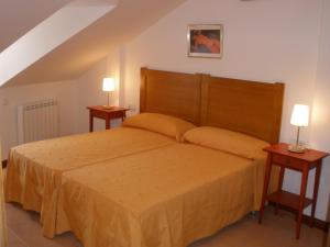 a bedroom with a large bed with two night stands at Alojamientos Turísticos Casco Antiguo in Cuenca