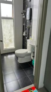 a bathroom with a toilet and a sink and a window at Sweet Homestay 3RM @ Penthouse Apartment in Brinchang in Brinchang