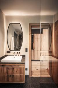 a bathroom with a sink and a mirror at Wagnerhof Apartments in Pertisau