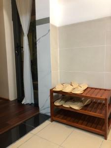a room with a shelf with shoes on it at Lightly Homestay in Ho Coc