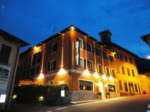 a large building with lights on the side of it at Hotel Adler in Menaggio