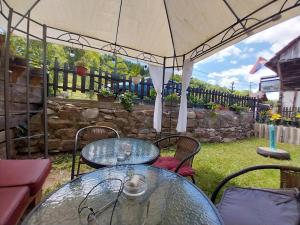 a patio with two tables and an umbrella at STD Kuća Talija in Kalna