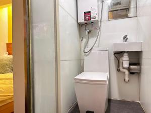 a bathroom with a toilet and a sink at i hotel-B&B in Hong Kong