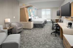 a hotel room with two beds and a desk at Courtyard by Marriott Las Cruces at NMSU in Las Cruces
