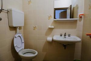 a bathroom with a toilet and a sink at Hotel Chiara in Rimini