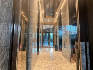 a hallway in a building with glass walls at 香港欧式装修豪华三室一厅 in Hong Kong