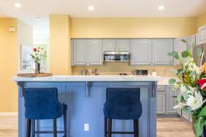 a kitchen with a blue island with two blue bar stools at Captivated Wine Country/Family in Cotati