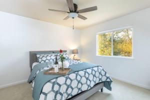 a bedroom with a bed and a ceiling fan at Captivated Wine Country/Family in Cotati
