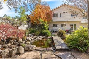 a garden with a pond in front of a house at Captivated Wine Country/Family in Cotati