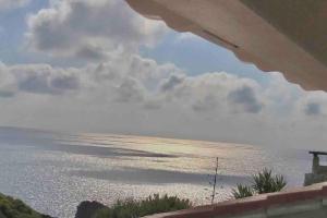 a view of the ocean from a balcony at Oasi del Relax - Seaside Peaceful Panoramic Terrace in ITALY - new Sardinia apartment 50 mt beach&sea full comfort air conditioning-WiFi-Parking-Privacy in Torre Dei Corsari