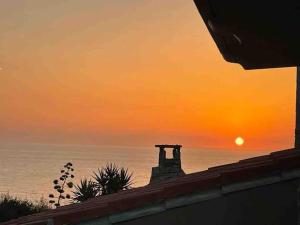 a sunset over the ocean with the sun in the sky at Oasi del Relax - Seaside Peaceful Panoramic Terrace in ITALY - new Sardinia apartment 50 mt beach&sea full comfort air conditioning-WiFi-Parking-Privacy in Torre Dei Corsari