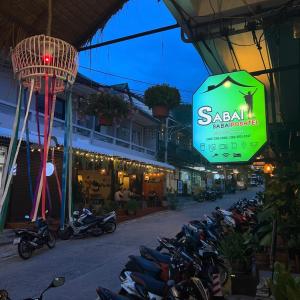 a group of motorcycles parked in a street at Sabai Sabai Poshtel & Motorbike Rental in Ko Tao