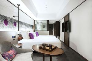 a hotel room with a bed and a table at Dhawa Yura Kyoto in Kyoto