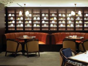 a dining room with two tables and chairs and plates at Dhawa Yura Kyoto in Kyoto