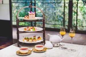 a table with two plates of food and two glasses of wine at Dhawa Yura Kyoto - Banyan Group in Kyoto