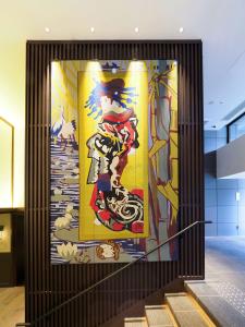 a large painting on the side of a wall in a building at Dhawa Yura Kyoto - Banyan Group in Kyoto