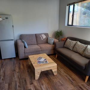 a living room with a couch and a coffee table at Let the good times roll-with inverter and wifi in Cape St Francis